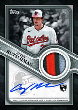 Baseball trading card featuring a player in a Orioles uniform with autograph and memorabilia details.